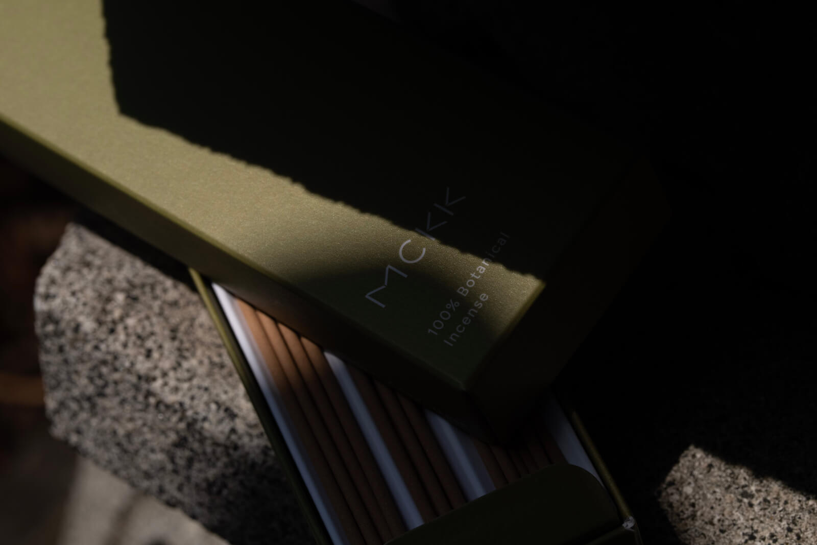 MCKKのお香の箱を開けた状態。自然の中で撮影されたイメージカット